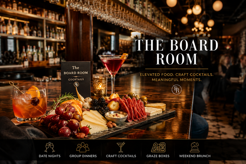 Upscale restaurant interior at The Board Room featuring an elegant charcuterie board, craft cocktails, warm ambient lighting, and a modern bar atmosphere in downtown Libertyville.
